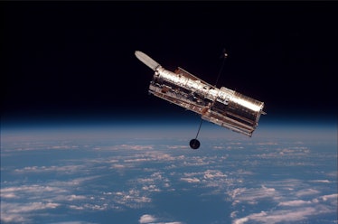 An image of the Hubble Space Telescope over Earth