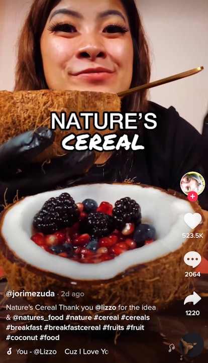 A woman enjoys fruit and coconut water — aka "nature's cereal" — in an actual coconut for TikTok. 