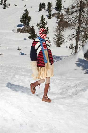 A model in a striped sweater, ski mas and beige silk dress by Miu Miu 