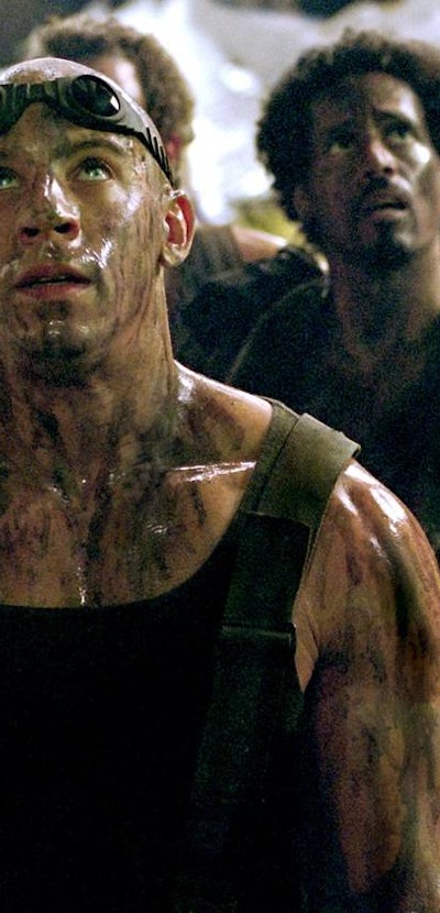 vin diesel with goggles on head looking up in chronicles of riddick