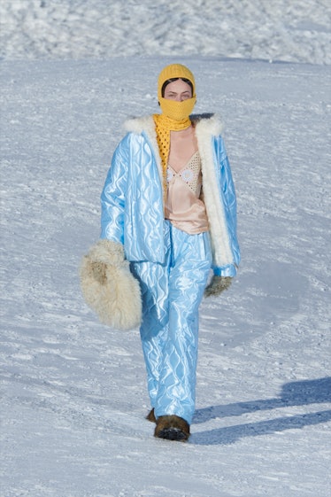 A model in a light blue coat and matching snow pants by Miu Miu 