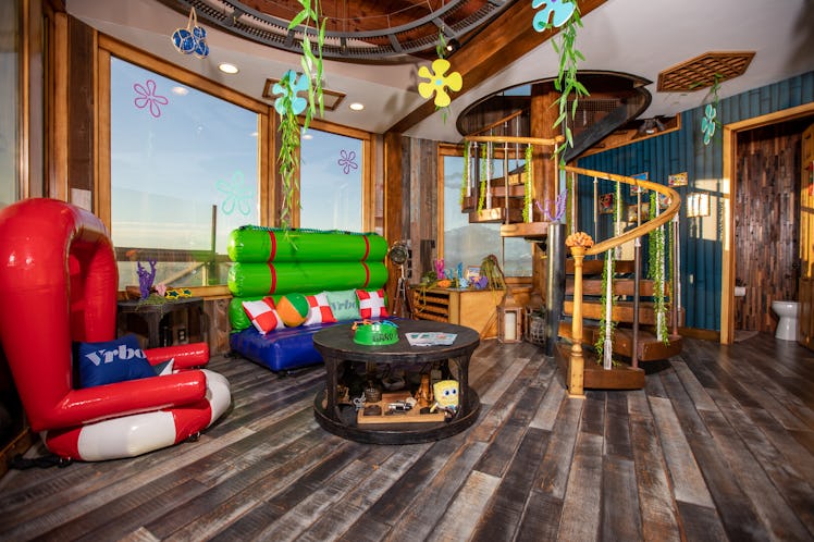 The interior of SpongeBob's pineapple home on Vrbo includes the iconic living room furniture and car...
