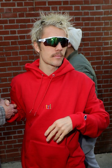 Justin Bieber wearing a red hoodie
