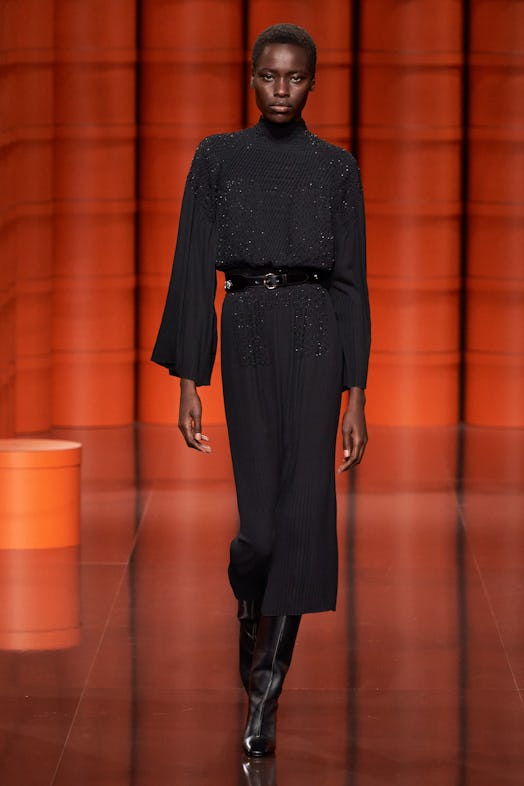 A female model walking in a black dress