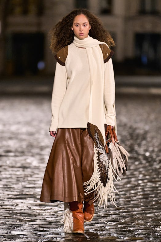 A young model walking in a white and brown coat of Gabriela Hearst