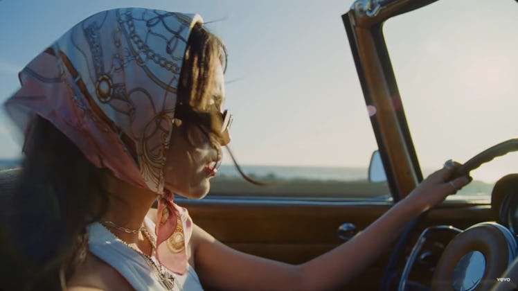 Olivia Rodrigo driving in the "Deja Vu" music video.