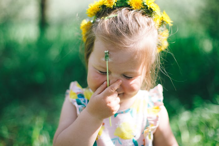close up of happy toddler wearing a flower crown