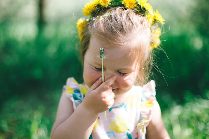 close up of happy toddler wearing a flower crown