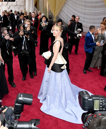 Saoirse Ronan posing in a Gucci black and light blue gown at the 92nd Annual Academy Awards