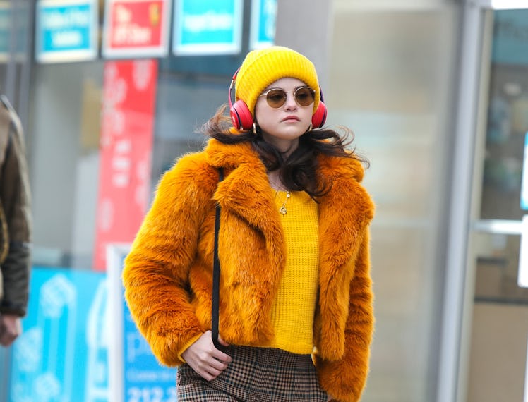 Selena Gomez wearing orange and yellow