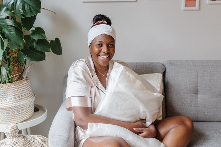 Founder of Glory Skincare Alisia Ford modeling on a couch.