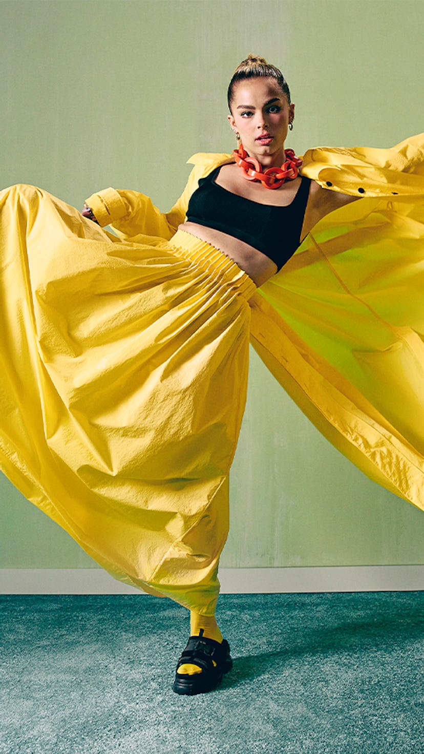 TikTok star Addison Rae wears a yellow outfit as she appears on Bustle's cover.