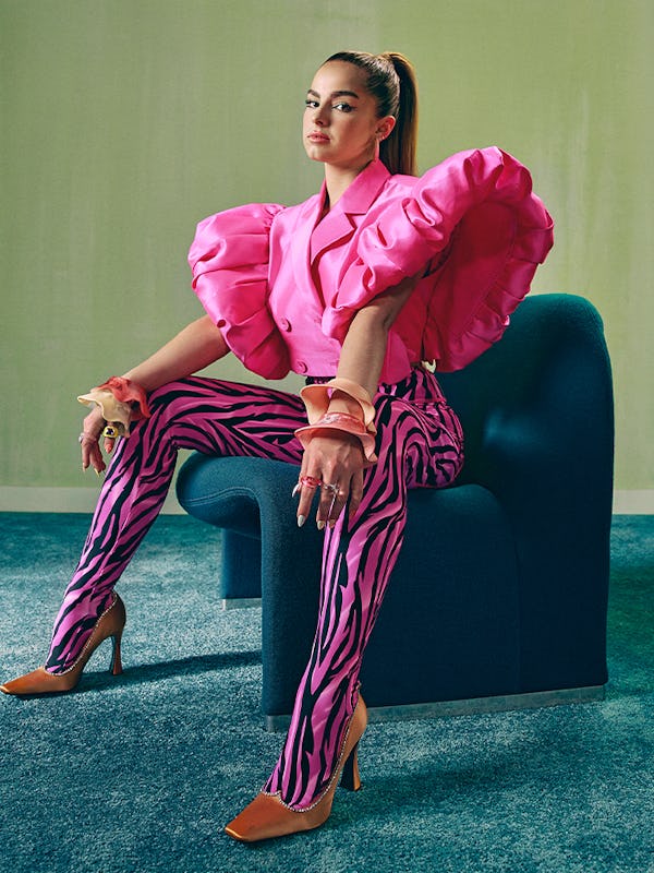 Addison Rae sitting on a chair in a pink Annakiki cropped blazer with puffy sleeves and Dinousar Des...