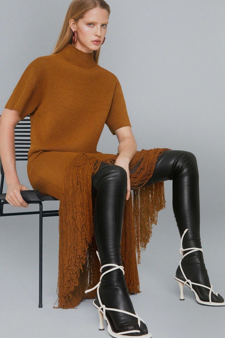 A model posing in a brown knit fringed dress from Proenza Schouler's pre-fall 2021 collection
