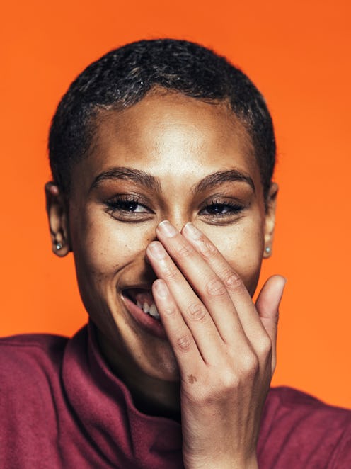 A woman covering her nose to hide sebaceous filaments