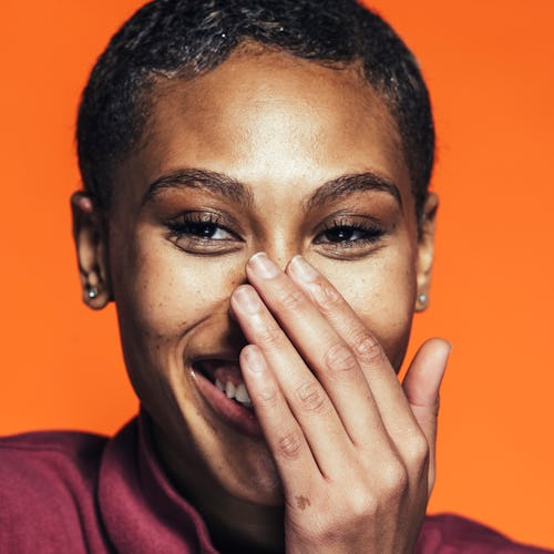 A woman covering her nose to hide sebaceous filaments