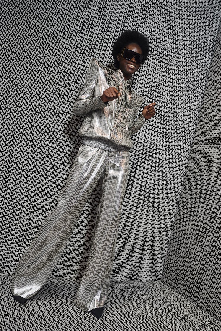 A model posing in a glittery suit from Balmain's pre-fall 2021 collection