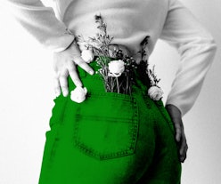 A woman in a white shirt and green pants with flowers in her back pocket as a symbol of sustainable ...