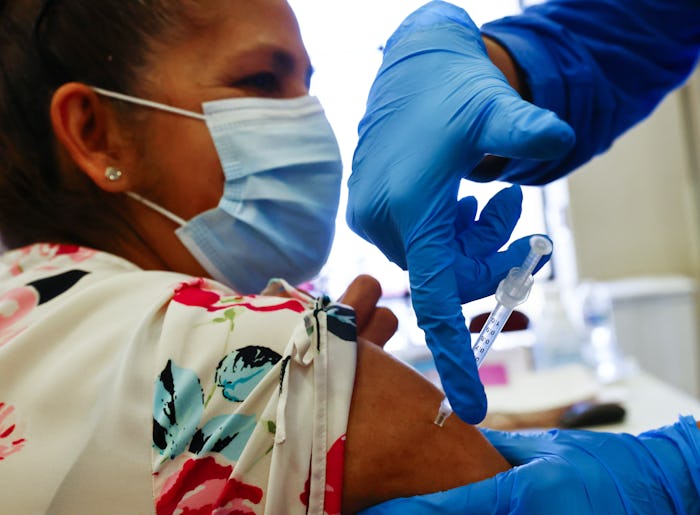 APPLE VALLEY, CALIFORNIA - MARCH 30: A woman receives a dose of a COVID-19 vaccine at a vaccination ...