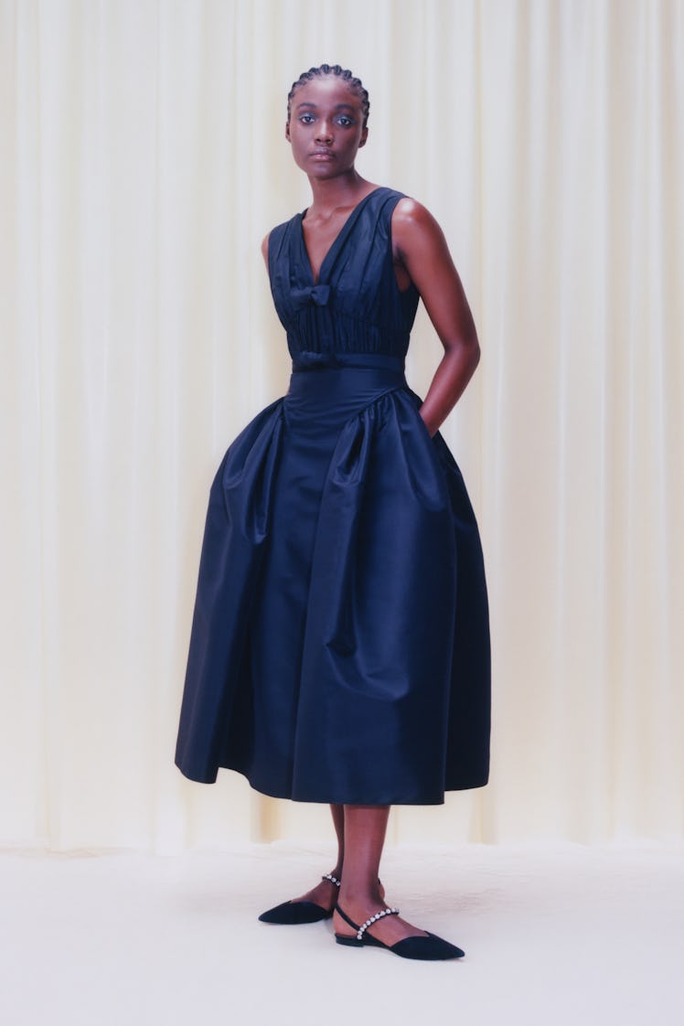 A model wearing a black midi dress from Self-Portrait's Pre-Fall 2021 collection
