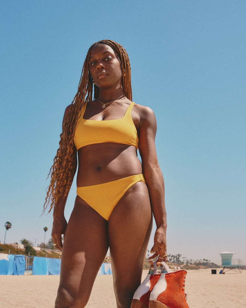 Model wearing yellow swimsuit from Everlane's first swimwear collection.