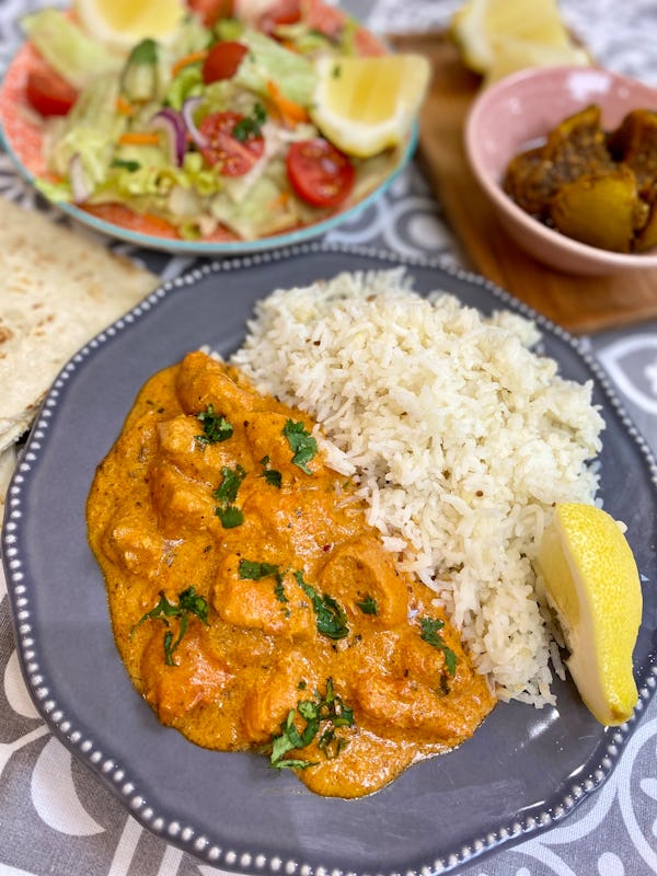 Butter chicken curry served on a plate with rice