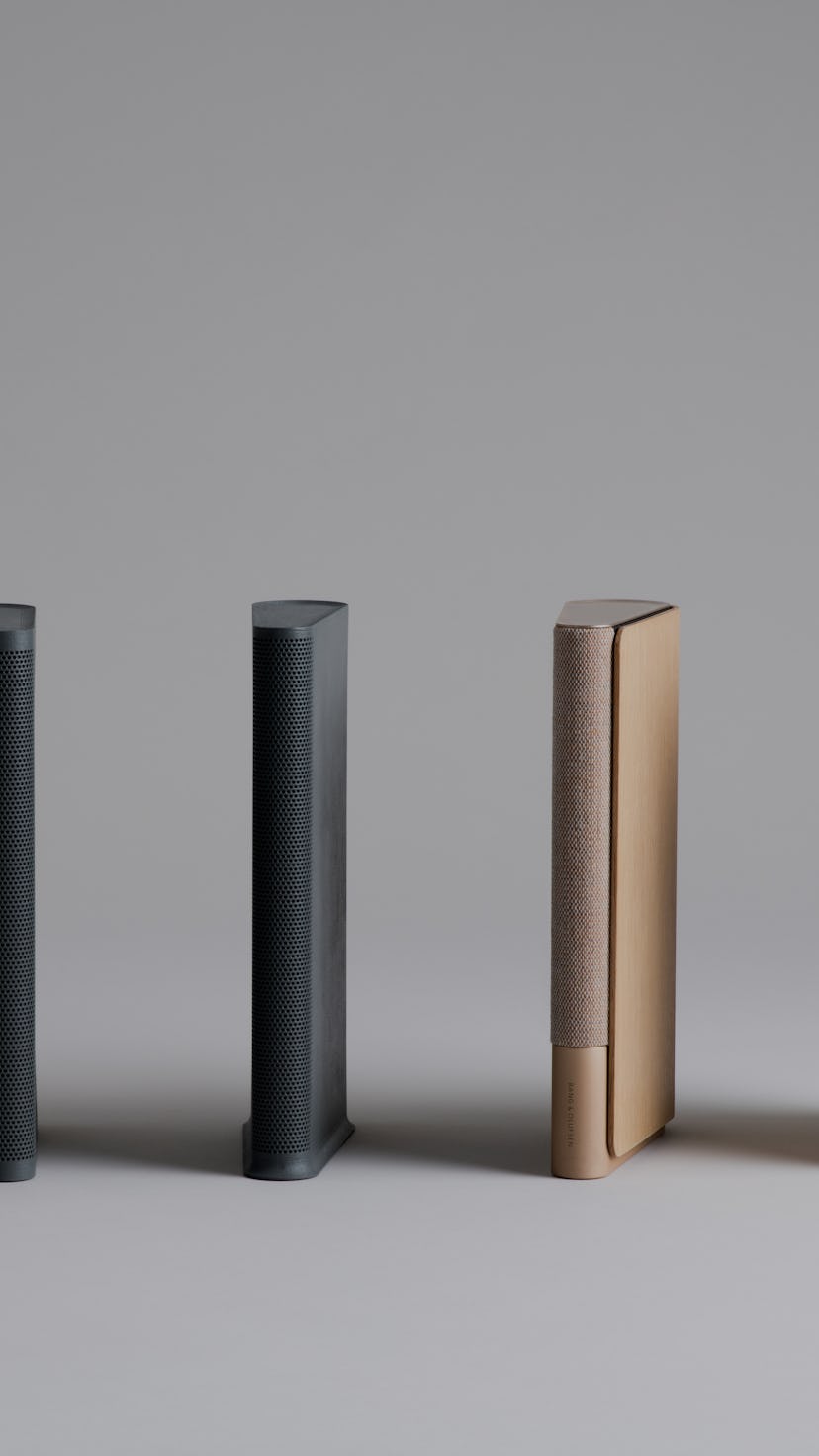 Lean speakers in golden and black tones by Bang and Olufsen. The pink ones are size models.