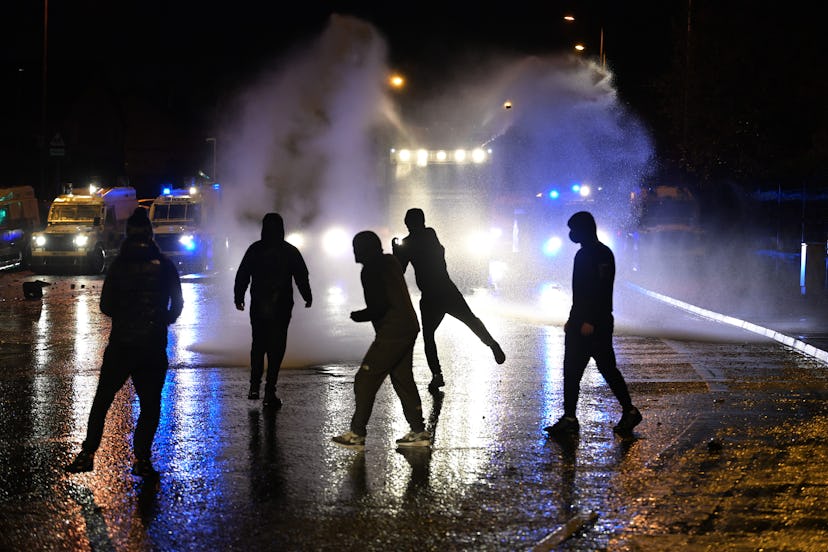   Nationalists attack police vehicles as they deploy water canons on Springfield Road on April 8, 20...