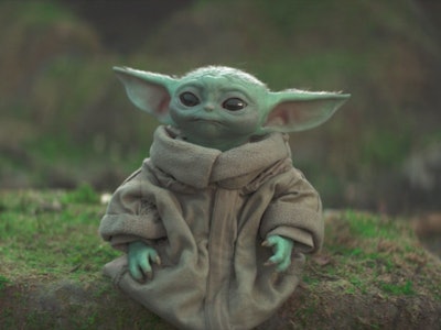 Grogu standing on a moss-covered rock in the Mandalorian Season 3