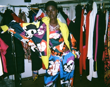 A model wearing a multi-color hoodie, wrap top and trousers by Alber Elbaz