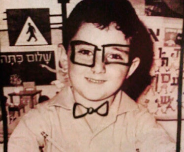 Young Alber Elbaz in a black-and-white photo with glasses and a bow tie doodle