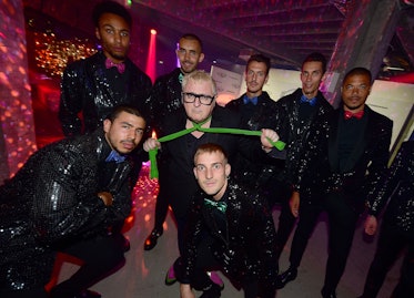 Alber Elbaz with a group of male models posing at a night club during a party
