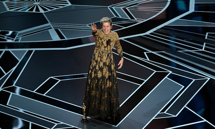Frances McDormand on stage waving at crowd