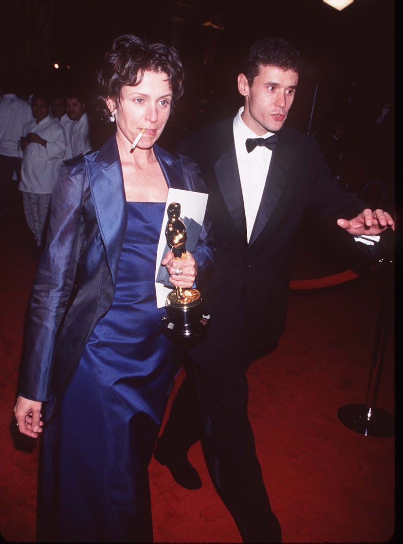 Frances McDormand smoking a cigarette and holding her Oscar