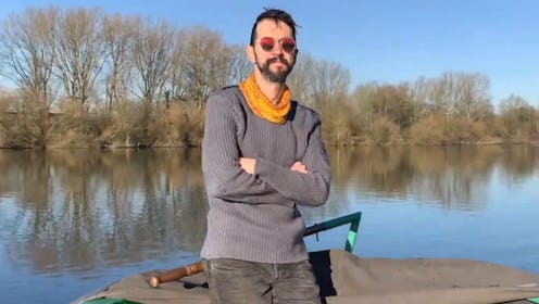 Myles McDowell posing for a photo next to a river