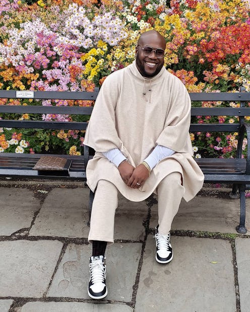 Wouri Vice in a long beige hoodie and matching pants, with a white shirt underneath
