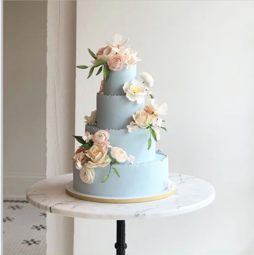 blue tiered cake with spring flowers