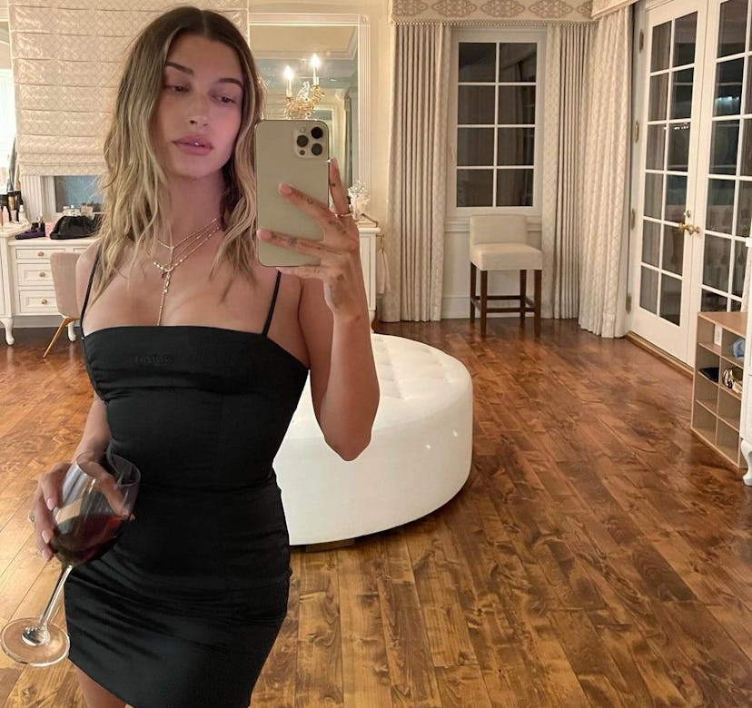 Hailey Bieber in a black mini dress.