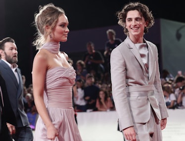 Lily-Rose Depp in a pink tulle dress and Timothee Chalamet in a beige suit 