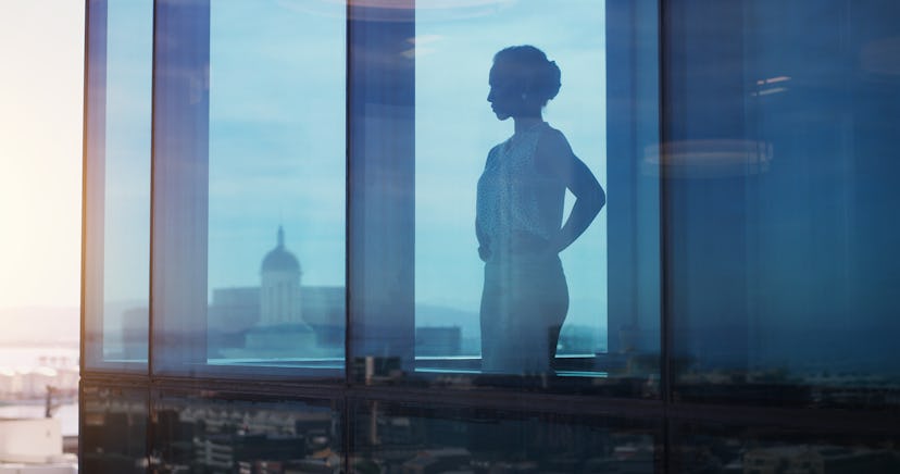 Businesswoman looking thoughtful while looking out a window