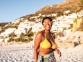 A woman on the beach during the summer uses beach captions for her bikini Instagram pics.