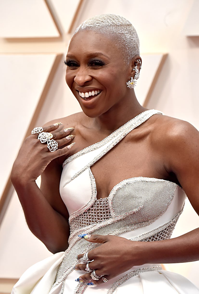 Cynthia Erivo in a white dress and chunky silver rings along with floral earrings at the Oscars