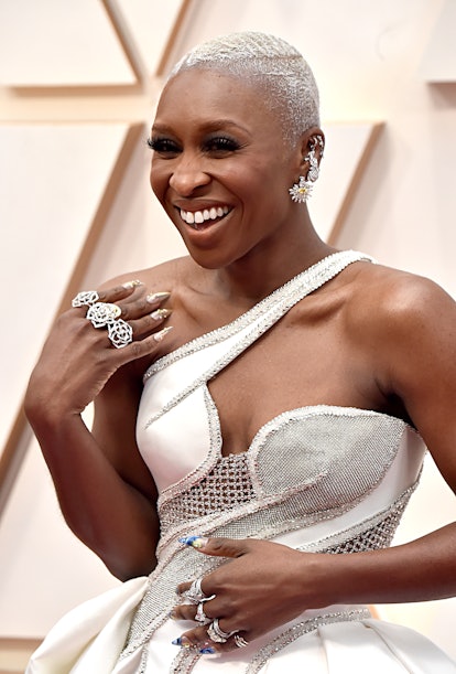 Cynthia Erivo in a white dress and chunky silver rings along with floral earrings at the Oscars