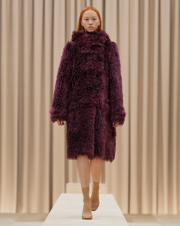 A model in a Burberry in a burgundy furry coat at the London Fashion Week