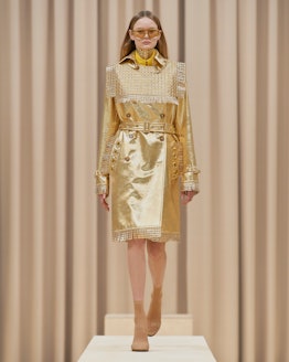 Model walks in Burberry's Fall/Winter 2021 show in an all gold outfit. 