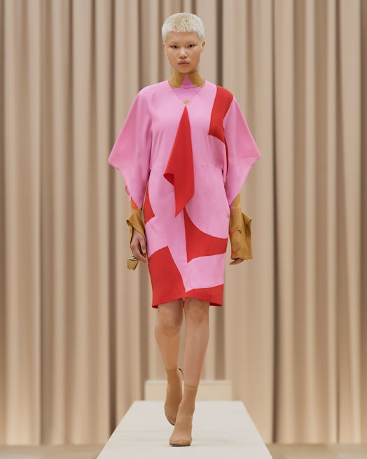 Model walks in Burberry's Fall/Winter 2021 show in a pink dress.