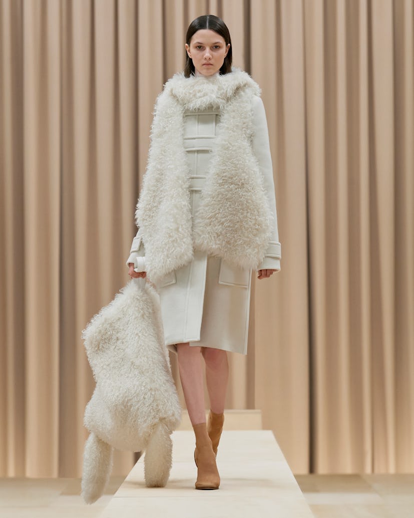 Model walks in Burberry's Fall/Winter 2021 show wearing an all-white outfit.