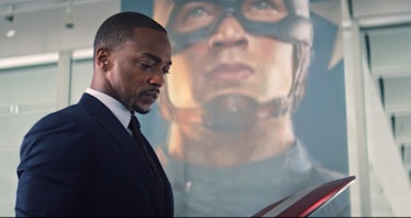 Anthony Mackie as Sam Wilson behind Captain America portrait in The Falcon and the Winter Soldier