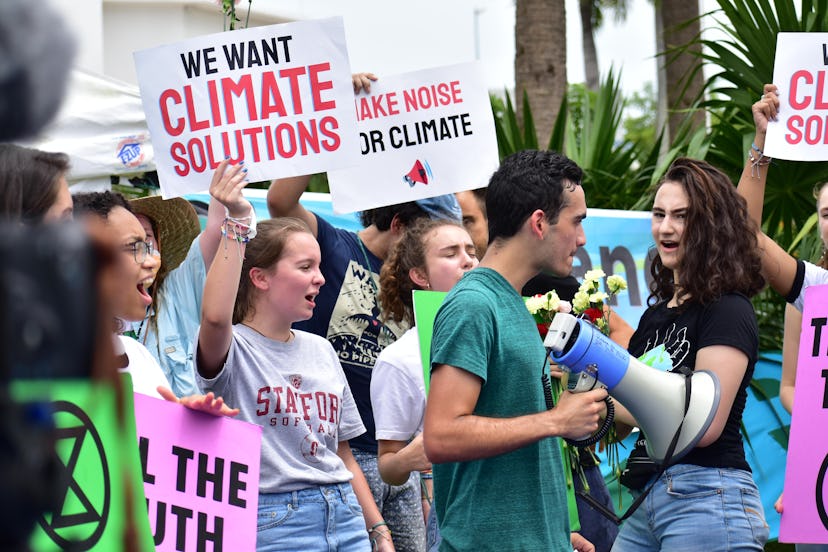 Climate change activists protesting with banners and requesting climate solutions