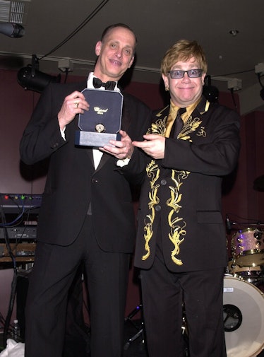 Elton John gifting a Chopard watch to John Waters at his 2001 Oscars party